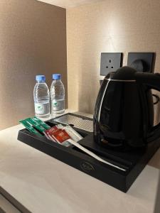 a toaster and two bottles of water on a counter at فندق سدو بوتيك التحلية in Medina +44 photos