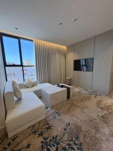 a large living room with a couch and a tv at فندق سدو بوتيك التحلية in Medina