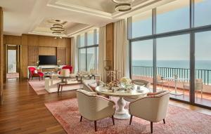 a living room with a table and chairs at Mandarin Oriental, Muscat in Muscat