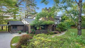 a brick house with a garden in front of it at The Castle Wentworth Falls in Wentworth Falls
