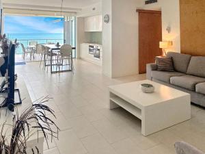 a living room with a couch and a table at 1 Bright Point Apartment 4203 in Nelly Bay