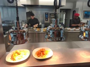 a kitchen with two plates of food on a counter at HI Poitiers - La Caserne in Poitiers +12 photos