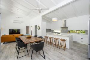 a kitchen and dining room with a wooden table and chairs at Papillon Bleu in Horseshoe Bay +22 photos