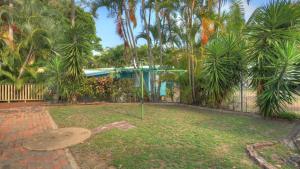 a garden with a bench in front of a house at Loyang Apartment 1 in Arcadia +5 photos
