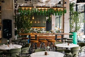a restaurant with tables and chairs and a bar at NanoApart by Solarento in Warsaw