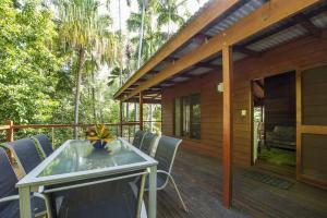 a patio with a table and chairs on a deck at Magnetic Effect in Arcadia