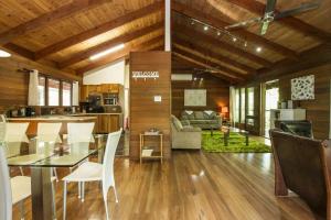 a kitchen and living room with a table and chairs at Magnetic Effect in Arcadia