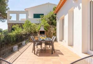 a table and chairs on the patio of a house at La Terrasse 1-Vue Mer Panoramique & Piscine, BBQ in Begur +148 photos