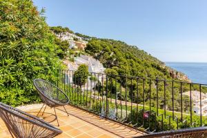 two chairs sitting on a balcony overlooking the ocean at La Terrasse 1-Vue Mer Panoramique & Piscine, BBQ in Begur