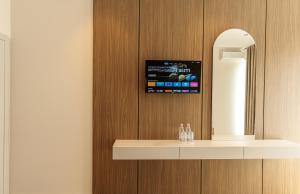 a bathroom with a counter with a mirror and a sink at Abeille Rooms in Himare