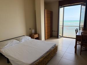 a bedroom with a bed and a view of the ocean at Residenza La Signora vista mare con ascensore in Marotta