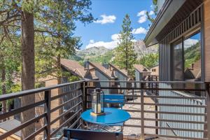 a balcony with a table and chairs on it at Alpenglow Loft condo in Olympic Valley