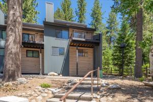 a house in the woods with a tree at Alpenglow Loft condo in Olympic Valley
