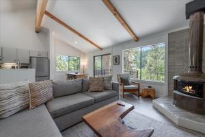a living room with a couch and a fireplace at Alpenglow Loft condo in Olympic Valley +29 photos