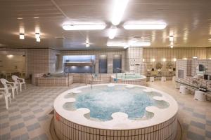 a large room with a hot tub and a spa at Art Hotel Asahikawa in Asahikawa