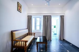 a living room with a couch and a table at Le Mont Lagoon Home Stay in Cochin