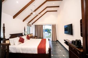 a hotel room with a bed and a window at Le Mont Lagoon Home Stay in Cochin