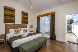 a bedroom with a large bed and a large window at Reflections Emerald Villa 1 in Picnic Bay