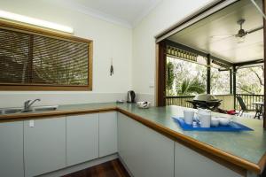 a kitchen with white cabinets and a counter top at Marramaninjie in Arcadia