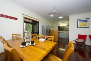 a dining room with a wooden table and chairs at Marramaninjie in Arcadia