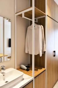 a bathroom with a sink and a mirror at Harbor Point Quoc Huong, Thao Dien in Ho Chi Minh City +31 photos