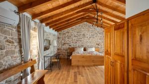a bedroom with a bed and a brick wall at Old House Grota by Villas Guide in Umag +20 photos