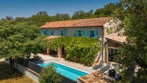 an external view of a house with a swimming pool at Old House Grota by Villas Guide in Umag