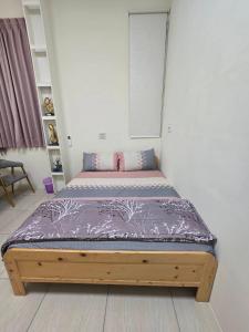 a small bed in a room with at 南田旅宿親子商務 in Fengyuan
