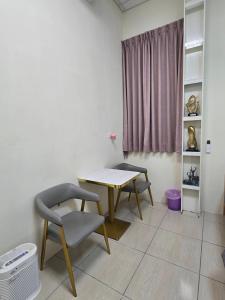 a dining room with a table and two chairs at 南田旅宿親子商務 in Fengyuan