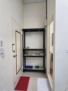 a bathroom with a walk in closet with a red rug at 南田旅宿親子商務 in Fengyuan