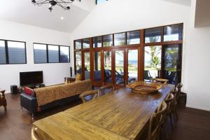 a living room with a wooden table and chairs at Beached on Magnetic in Picnic Bay