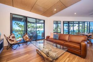a living room with a couch and chairs at Headland House in Picnic Bay