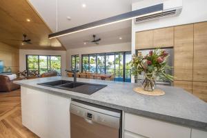 a kitchen with a sink and a counter top at Headland House in Picnic Bay
