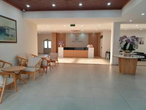 a lobby with a table and chairs and a counter at Juna hotel - Condotel in Thanh Hóa