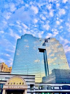a tall glass building with a sky in the background at Sofitel Harbin in Harbin +54 photos