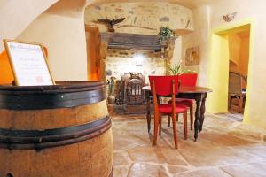a room with a table and chairs and a fireplace at Chambre d'Hôtes La Chadeleufade in Chadeleuf
