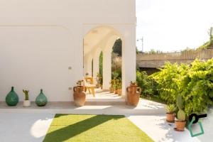 a courtyard with potted plants and an archway at Hotiday Ponza Scogliera in Ponza