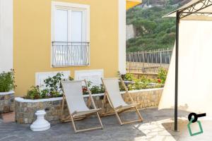 two chairs sitting in front of a building at Hotiday Ponza Scogliera in Ponza