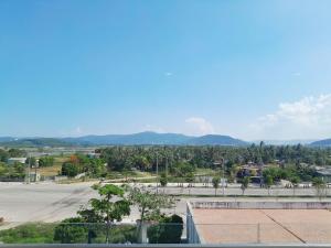 an empty parking lot with mountains in the background at Juna hotel - Condotel in Thanh Hóa