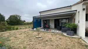 a house with a garden with a small tree in the yard at Chez Cathie & Didier in Revel