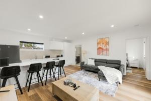 a living room with a couch and a table at Ralph Escapes Kingsley in Perth