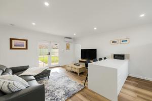 a living room with a couch and a table at Ralph Escapes Kingsley in Perth