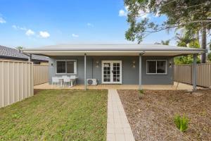 a grey house with a fence and a yard at Ralph Escapes Kingsley in Perth