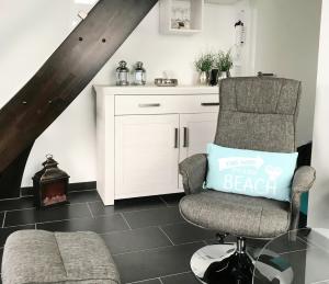 a living room with a chair and a couch at Sonnendeck 36 - Großenbrode in Grossenbrode