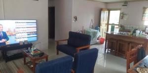 a woman standing in a living room with a tv at Vatudei Homestay - Yasawa Islands in Somosomo