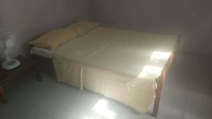 a small bed in a room with a small table at Vatudei Homestay - Yasawa Islands in Somosomo +16 photos