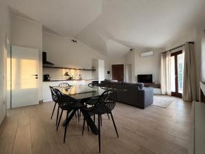 a living room with a table and chairs and a couch at Casa Tanca Marchese in Marrùbiu
