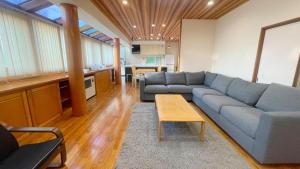 a living room with a blue couch and a table at Tabinoteitaku Zao Miyagi in Zao +132 photos