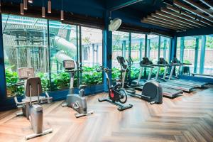 a gym with treadmills and elliptical machines at Trival Property Homestay Sri Indah Sandakan in Sandakan