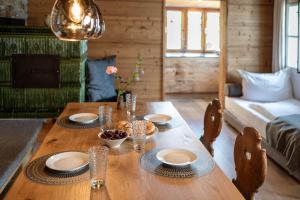a wooden table with plates and bowls of food on it at Seehaus 96 Hallstatt in Hallstatt